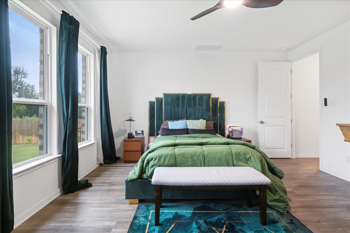 209 Terra Mnr Trail Georgetown, TX 78628 - Photo 16 of 40 Bedroom featuring wood finished floors and a ceiling fan