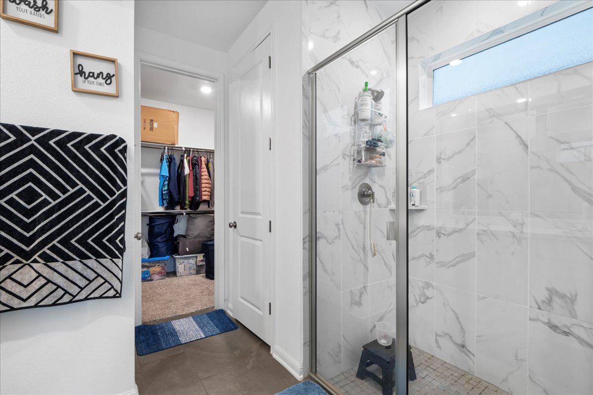 209 Terra Mnr Trail Georgetown, TX 78628 - Photo 18 of 40 Full bath with a marble finish shower and a spacious closet