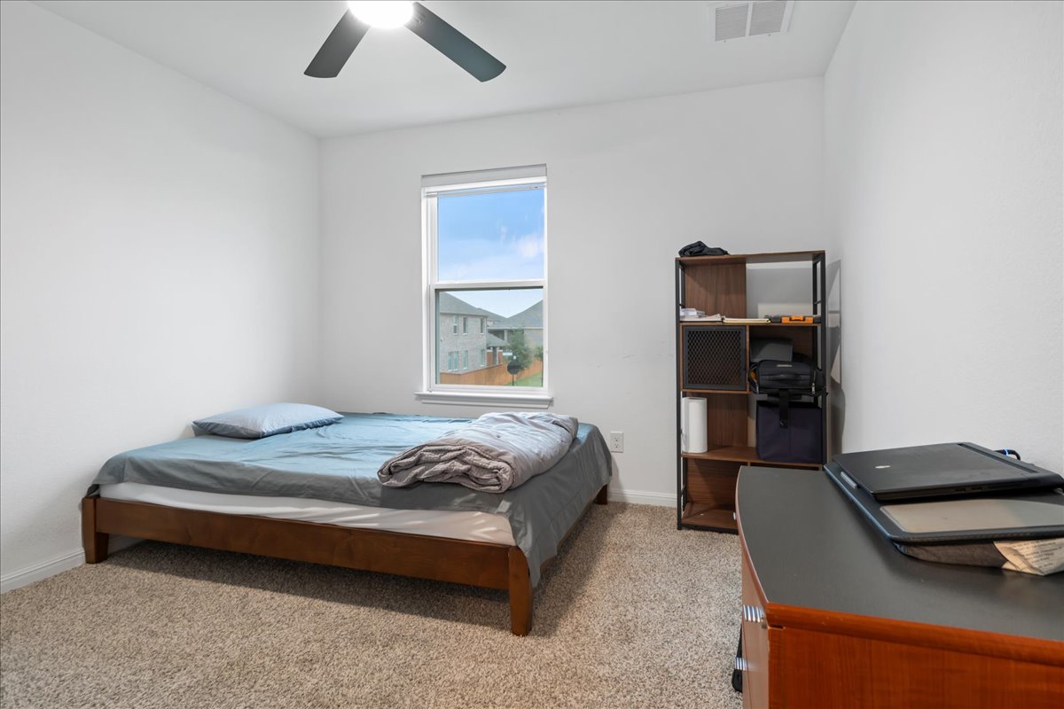 209 Terra Mnr Trail Georgetown, TX 78628 - Photo 22 of 40 Bedroom with light carpet and ceiling fan
