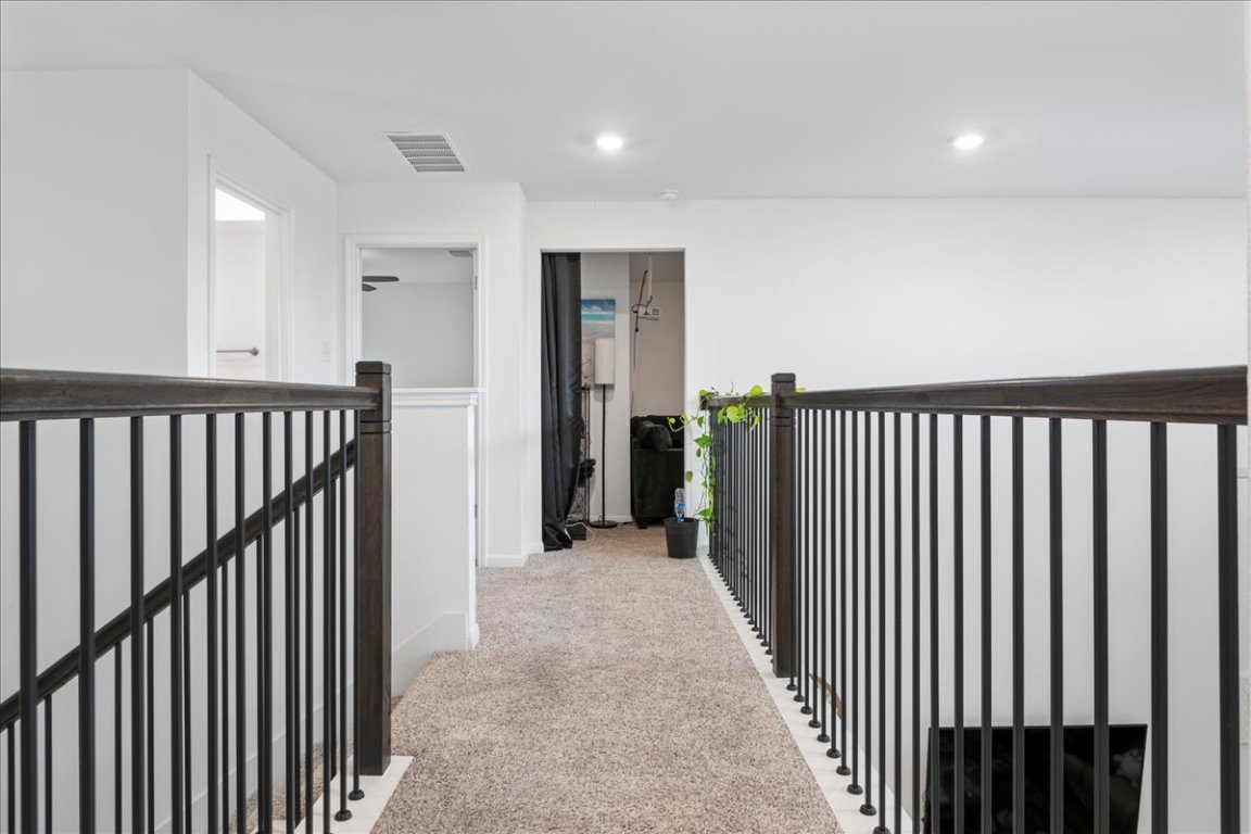 209 Terra Mnr Trail Georgetown, TX 78628 - Photo 24 of 40 Hallway featuring light carpet, an upstairs landing, and recessed lighting