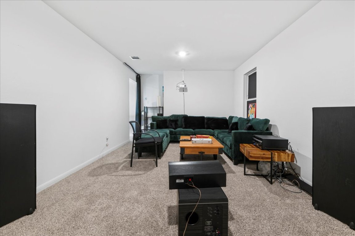 209 Terra Mnr Trail Georgetown, TX 78628 - Photo 28 of 40 Living room featuring light colored carpet