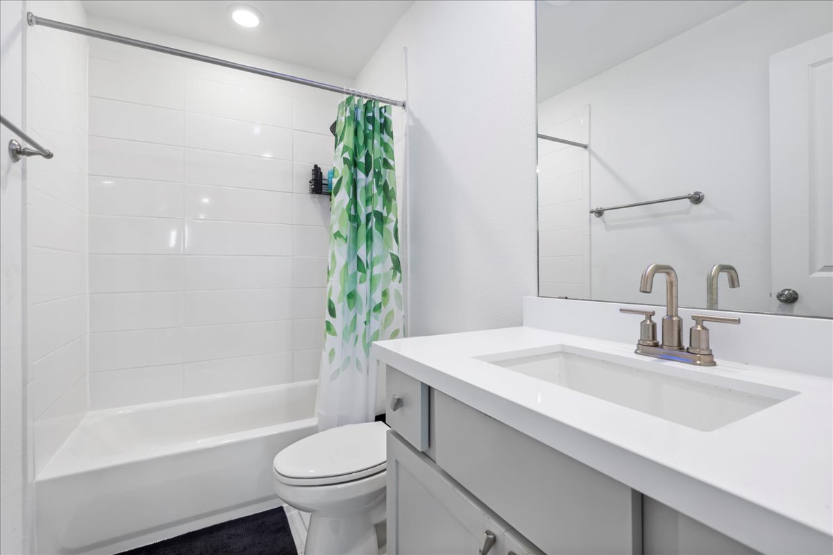 209 Terra Mnr Trail Georgetown, TX 78628 - Photo 29 of 40 Bathroom featuring vanity and shower / bathtub combination with curtain