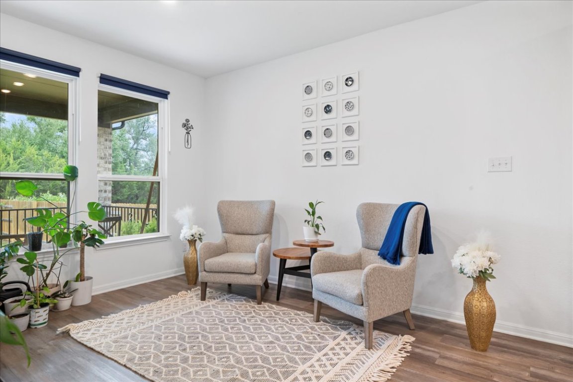 209 Terra Mnr Trail Georgetown, TX 78628 - Photo 31 of 40 Living area featuring dark wood finished floors and baseboards