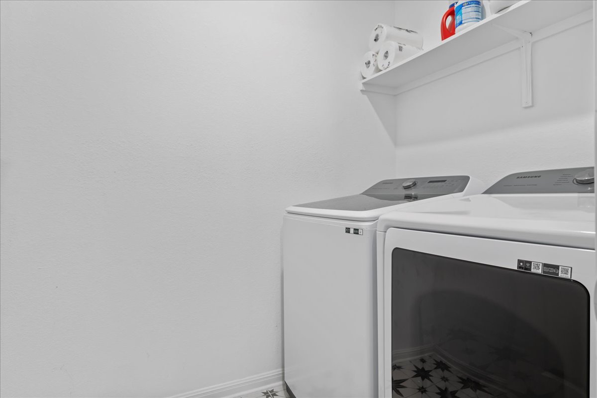 209 Terra Mnr Trail Georgetown, TX 78628 - Photo 35 of 40 Laundry room with washing machine and dryer and baseboards