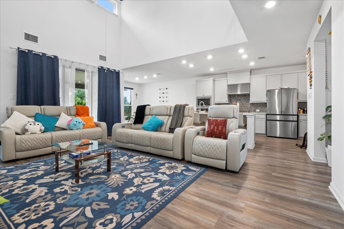 209 Terra Mnr Trail Georgetown, TX 78628 - Photo 5 of 40 Living area with light wood-style floors, recessed lighting, and a high ceiling