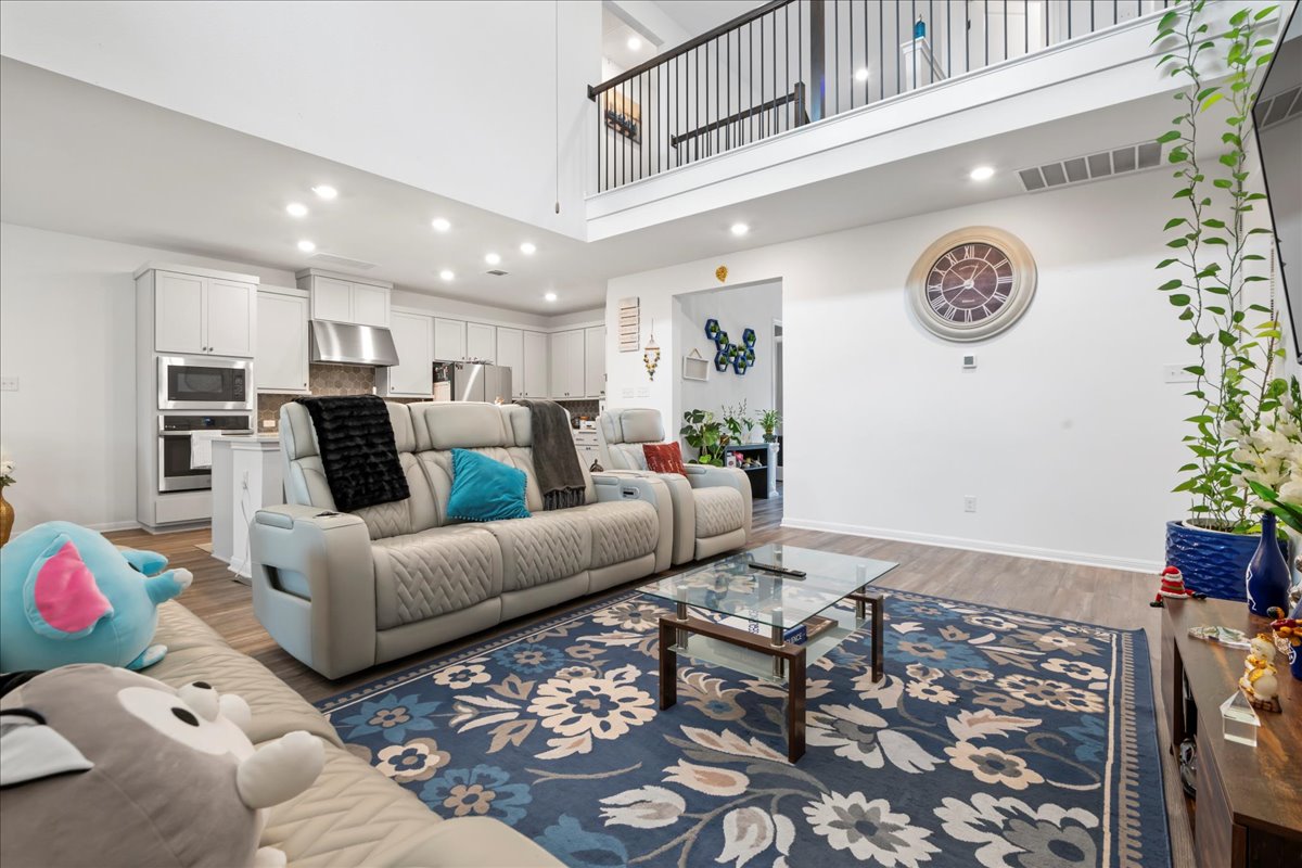 209 Terra Mnr Trail Georgetown, TX 78628 - Photo 6 of 40 Living room featuring recessed lighting, light wood-style flooring, and a high ceiling