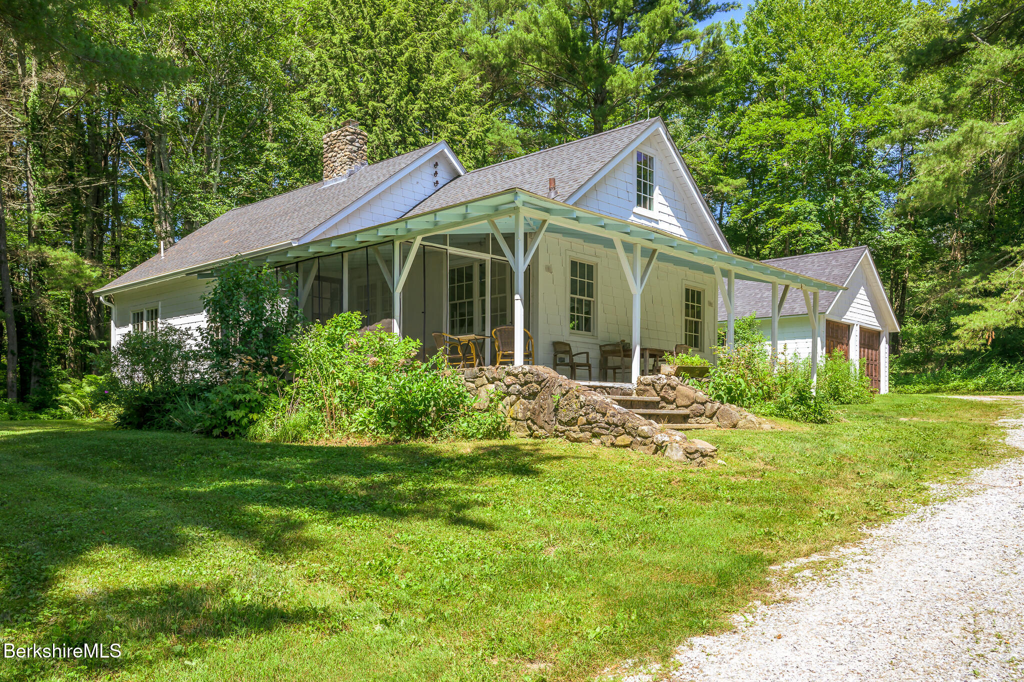 a view of a house with yard and green space