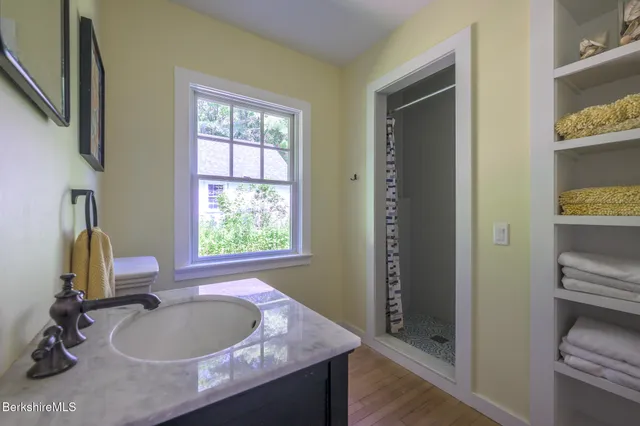 a bath room with a sink and a mirror