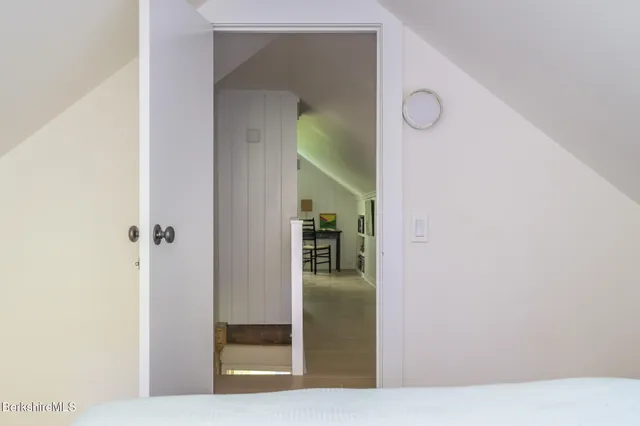 a view of a hallway with wooden floor and entryway