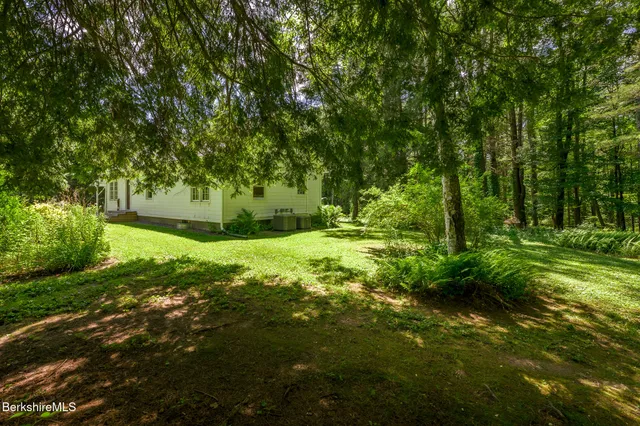 a view of a house with garden and yard