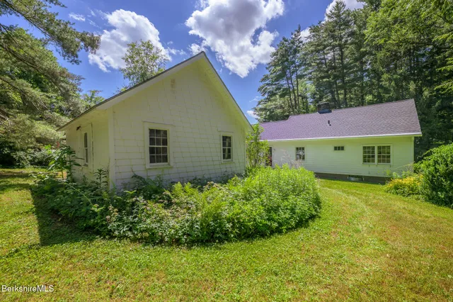 a large yard with lots of green space and trees
