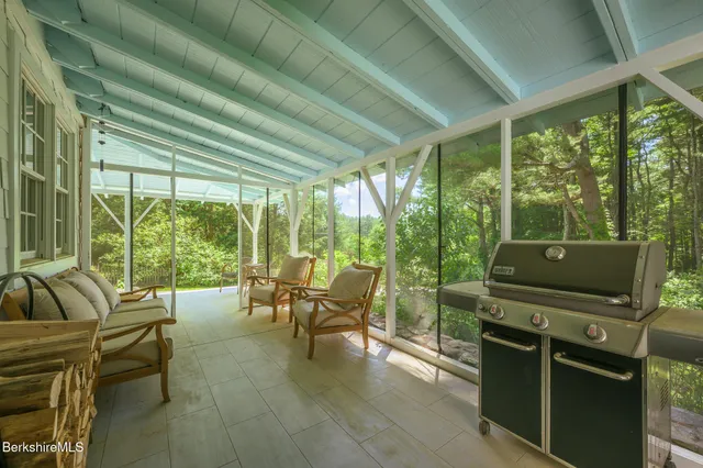a view of a patio with couches chairs and backyard