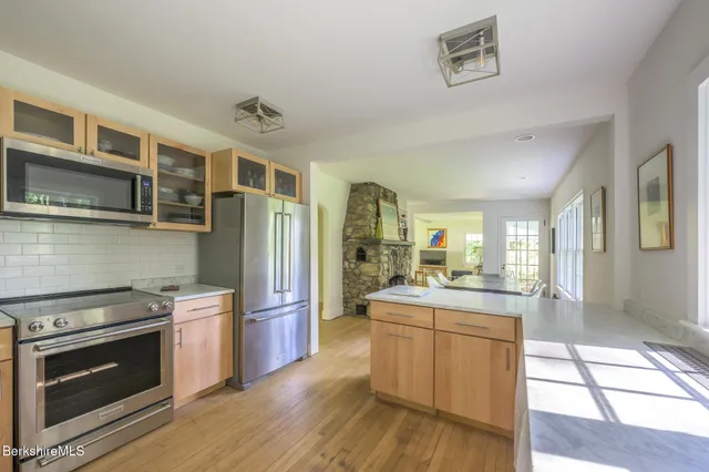 a kitchen with stainless steel appliances granite countertop a stove and a refrigerator