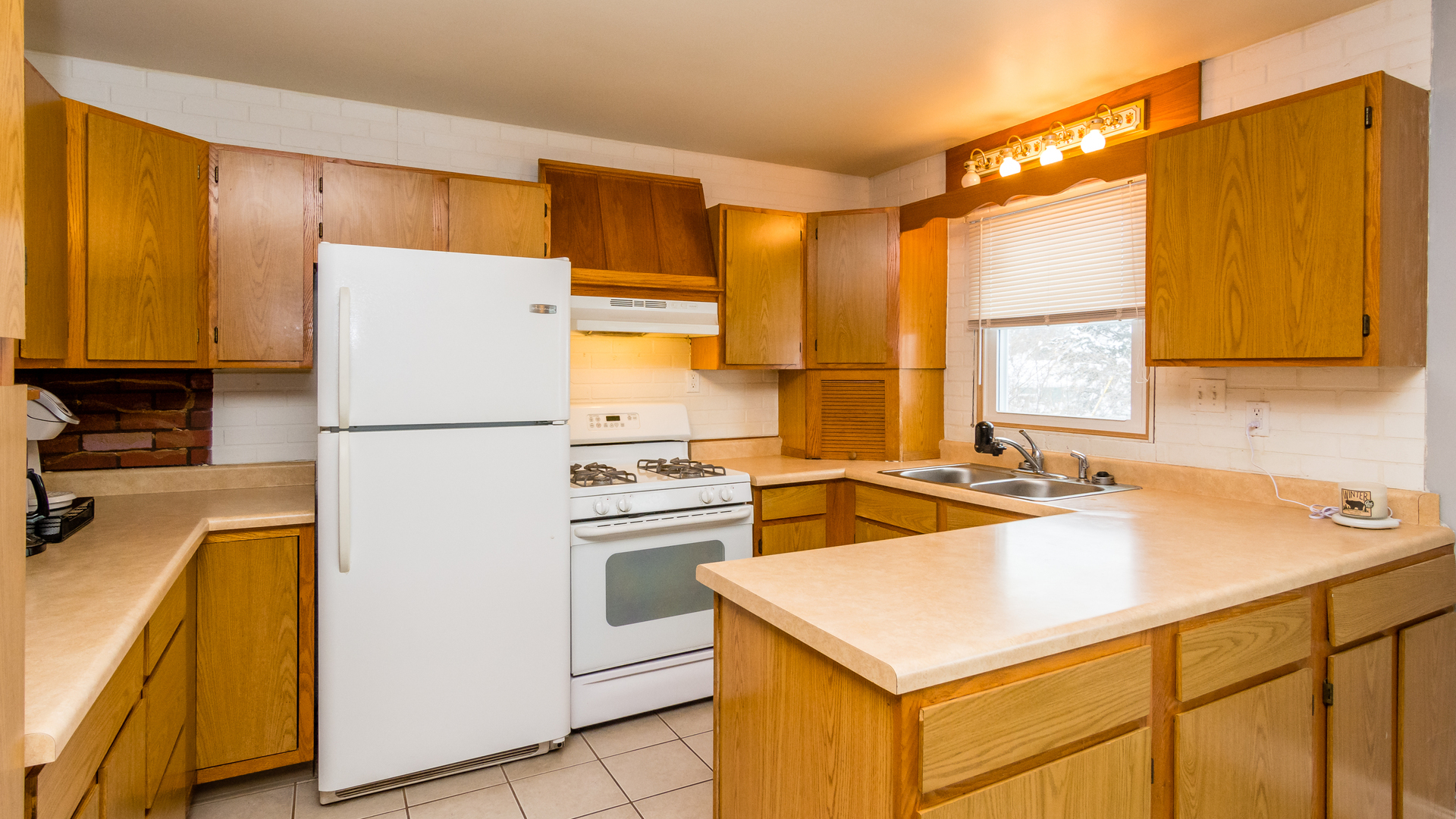 313 Healy Avenue Romeoville, IL 60446 - Photo 11 of 24 a kitchen with a refrigerator a sink and a stove
