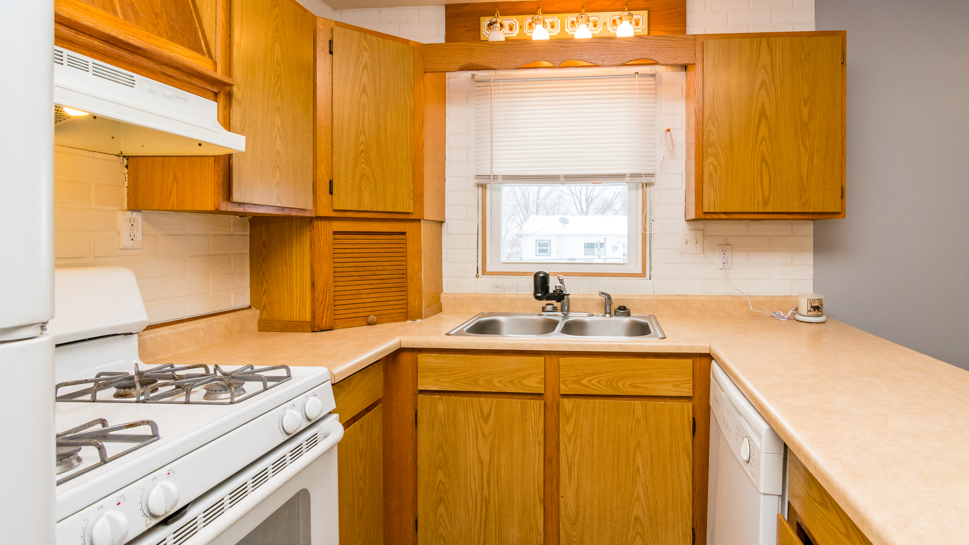 313 Healy Avenue Romeoville, IL 60446 - Photo 12 of 24 a kitchen with a sink stove and cabinets