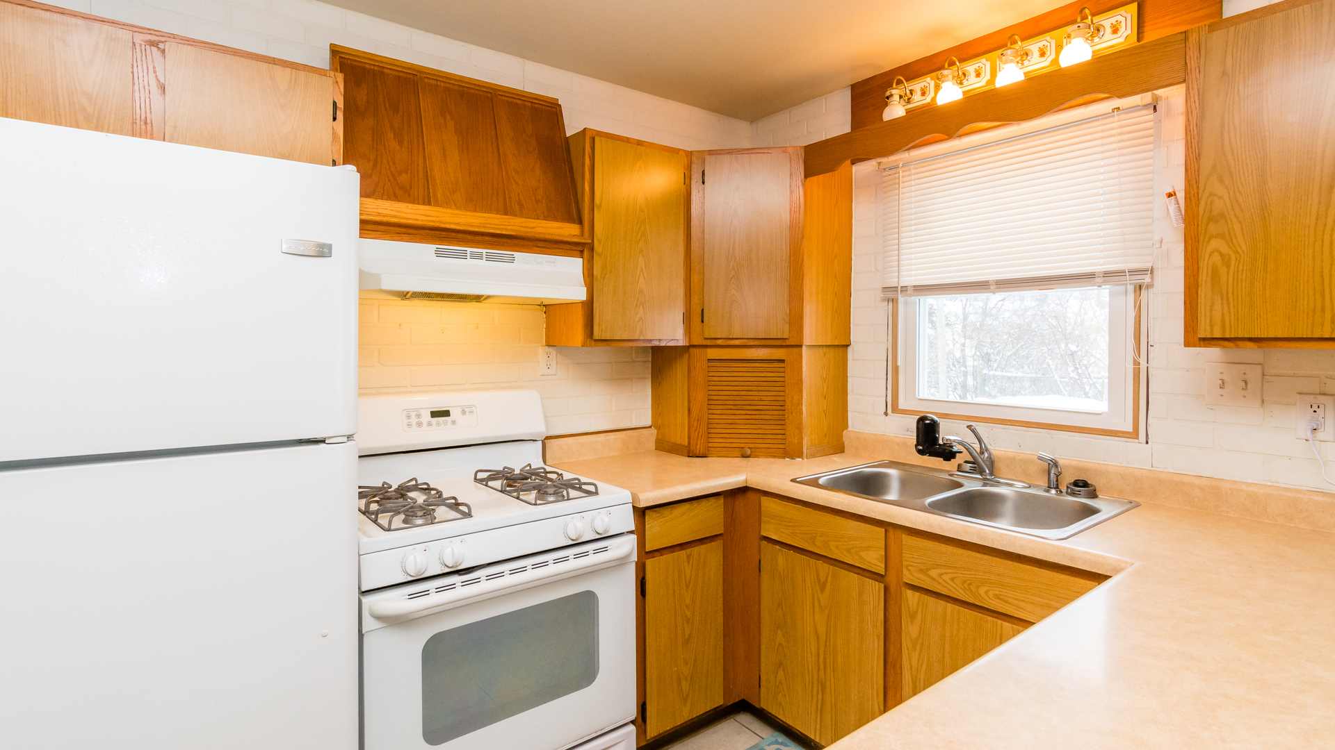 313 Healy Avenue Romeoville, IL 60446 - Photo 13 of 24 a kitchen with a sink a stove and a refrigerator