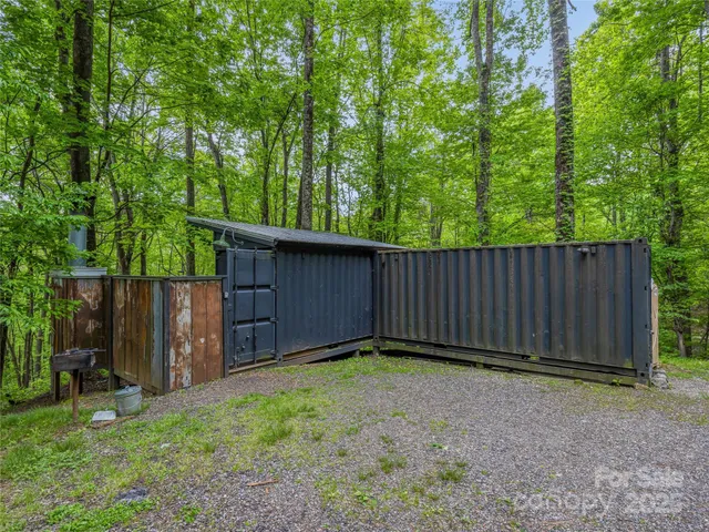 a view of wooden fence under a large tree
