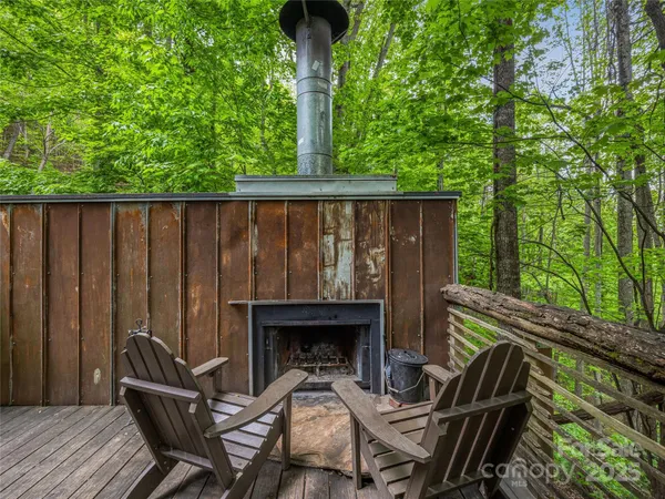 a view of backyard with deck and outdoor seating
