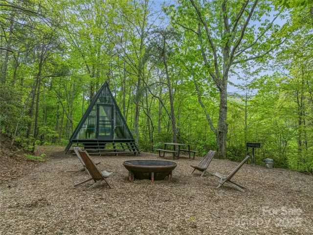 a view of backyard with wooden stairs and a fence