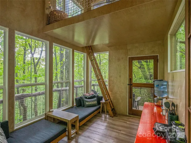 a living room with furniture and a floor to ceiling window