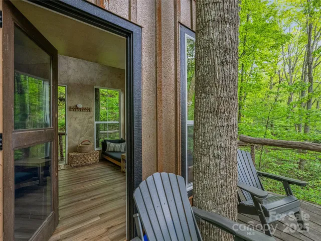 a porch with a bench next to a yard