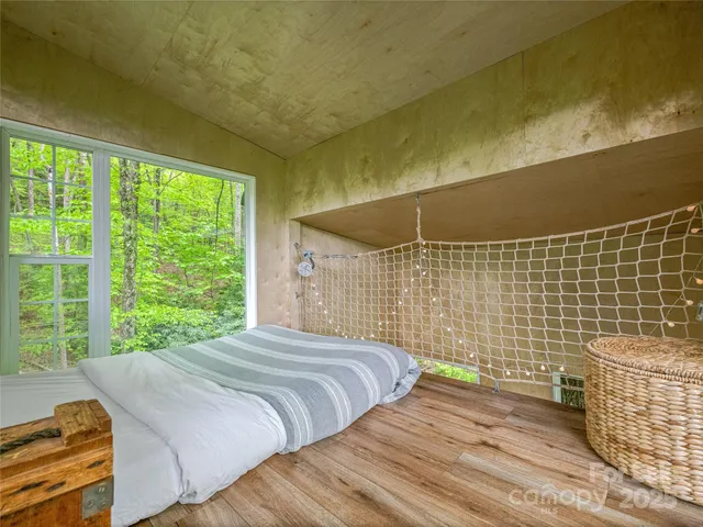 a bedroom with a bed and a window