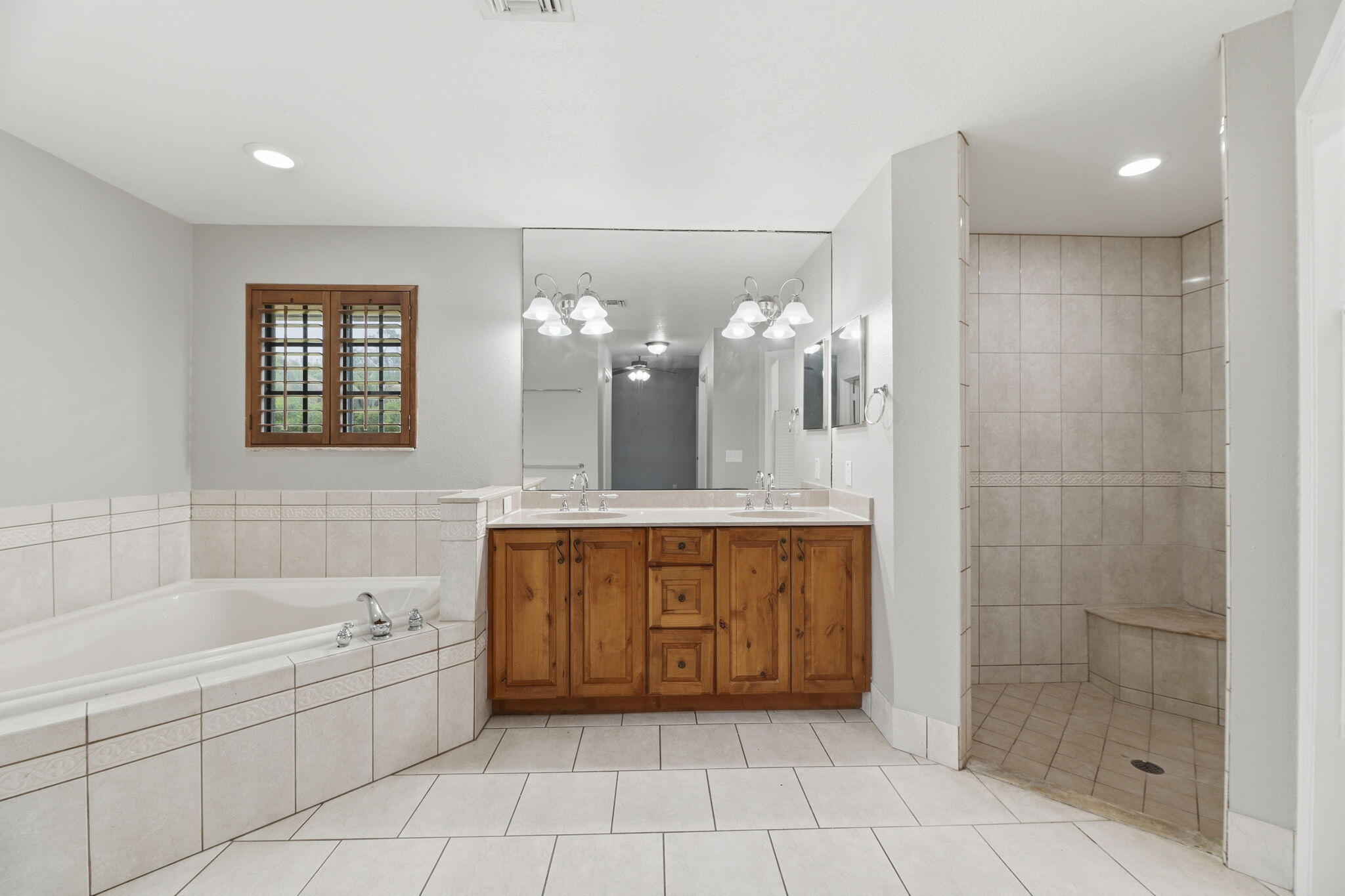 15731 85th Road North Loxahatchee, FL 33470 - Photo 33 of 65 a spacious bathroom with a tub shower and sink