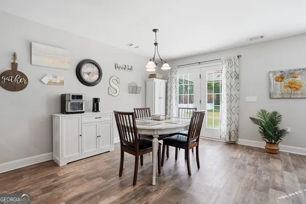 a view of a dining room with furniture wooden floor and chandelier