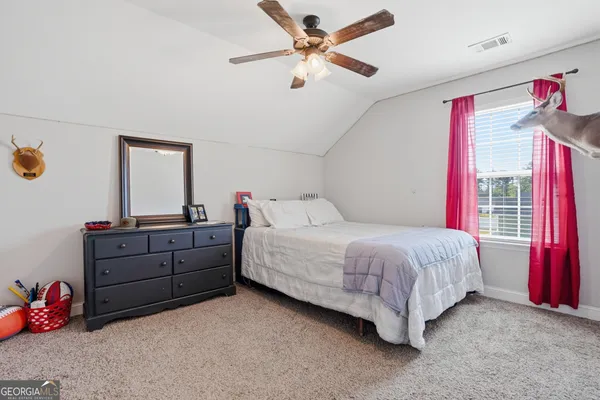 a bed room with a bed and a window