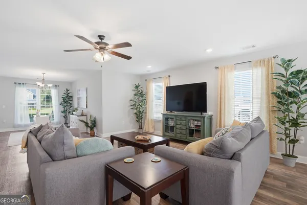 a living room with furniture a table and a chandelier