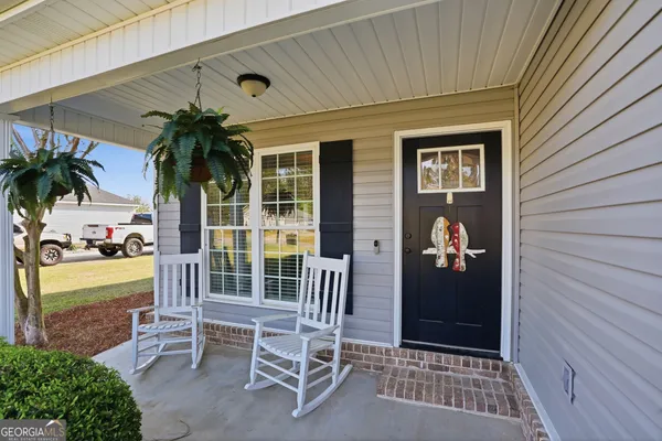 a front view of a house with outdoor seating