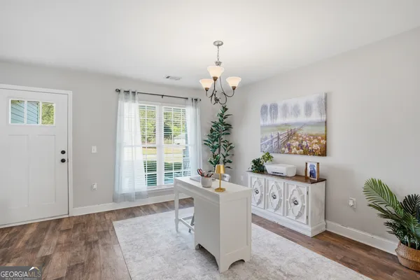 a living room with furniture and a chandelier