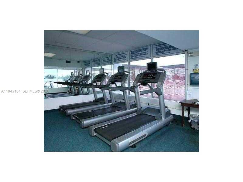 100 Lincoln Road, Unit 1440 Miami Beach, FL 33139 - Photo 14 of 27 a living room with furniture and a chandelier