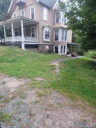 a view of house with yard