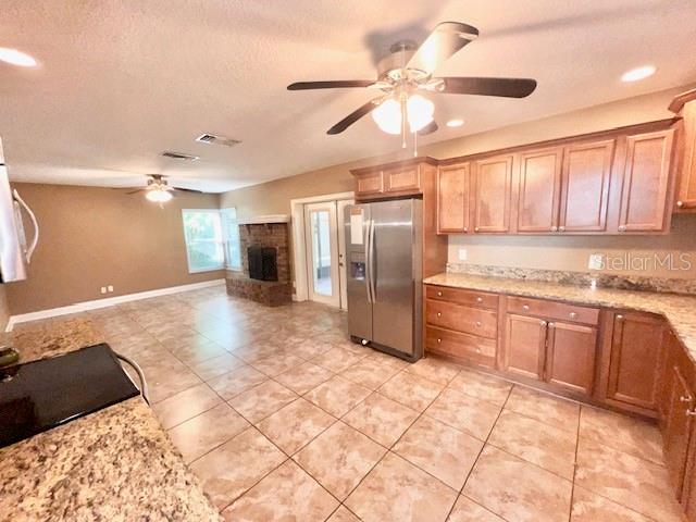2146 Kimberwicke Circle Oviedo, FL 32765 - Photo 7 of 20 a kitchen with stainless steel appliances granite countertop a refrigerator and a sink
