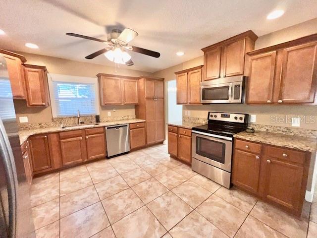 2146 Kimberwicke Circle Oviedo, FL 32765 - Photo 8 of 20 a kitchen with stainless steel appliances granite countertop a stove sink and microwave
