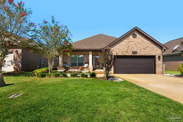 a view of a house with a yard and sitting area