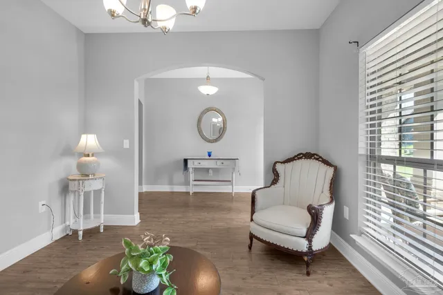 a living room with furniture a window and a chandelier