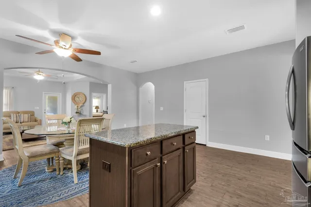 a kitchen with a table chairs and a refrigerator
