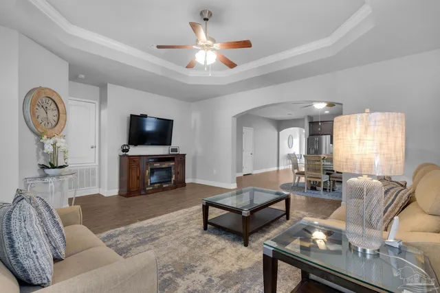 a living room with furniture a fireplace and a flat screen tv