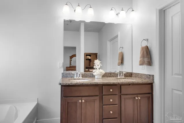 a bathroom with a double vanity sink and a mirror