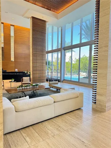 a living room with furniture and large windows