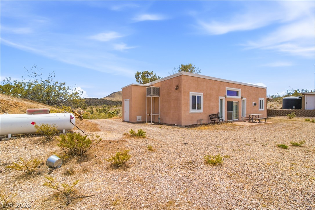 Rocking S Ranch Road Searchlight, NV 89046 - Photo 10 of 47 An adobe-style dwelling nestled in a sun-drenched desert landscape offers peaceful seclusion.