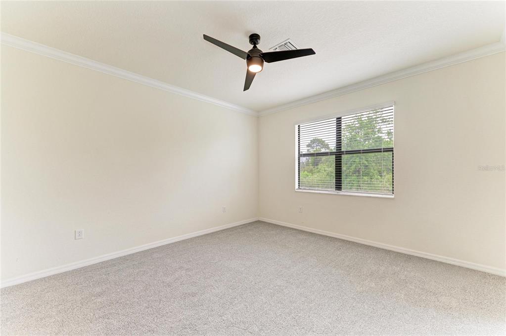 12434 Amica Loop Venice, FL 34293 - Photo 19 of 74 an empty room with ceiling fan and window