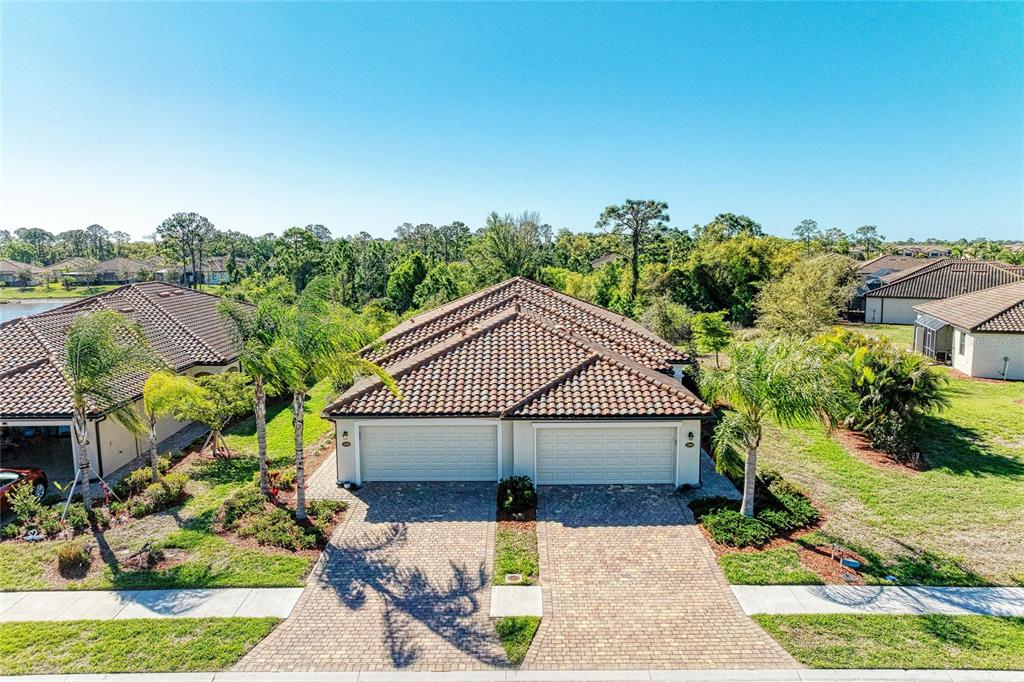 12434 Amica Loop Venice, FL 34293 - Photo 2 of 74 a house with green field in front of it