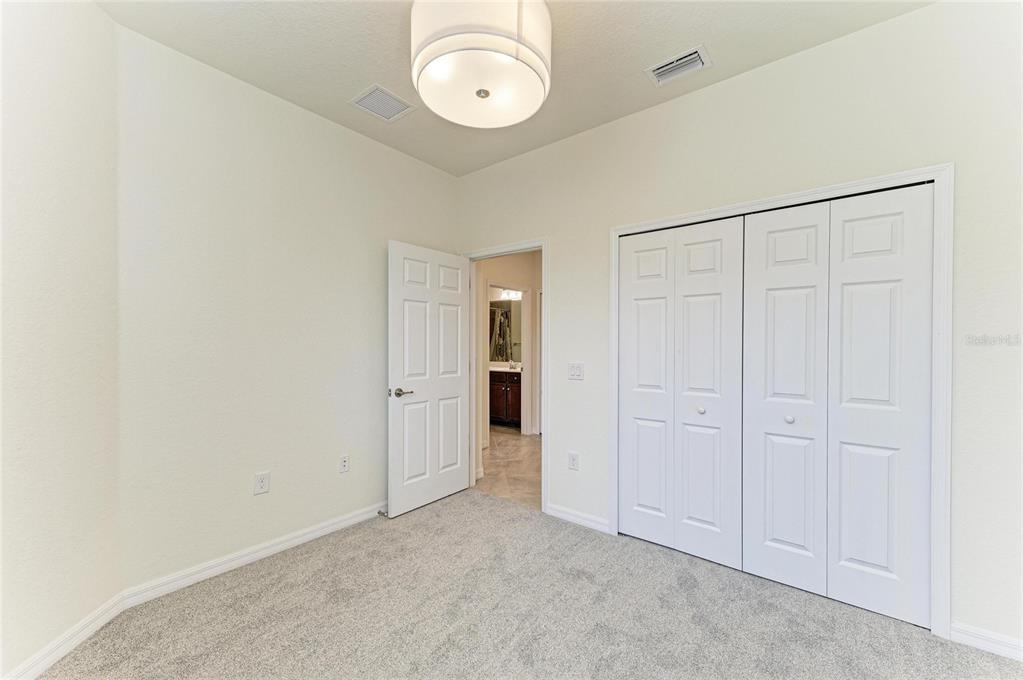 12434 Amica Loop Venice, FL 34293 - Photo 27 of 74 an empty room with a mirror and a window