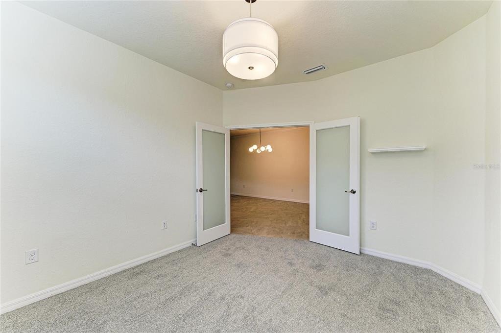 12434 Amica Loop Venice, FL 34293 - Photo 30 of 74 a view of an empty room and a window