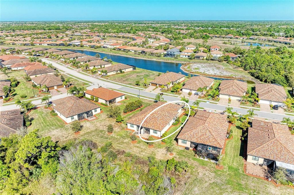 12434 Amica Loop Venice, FL 34293 - Photo 39 of 74 an aerial view of residential houses with outdoor space