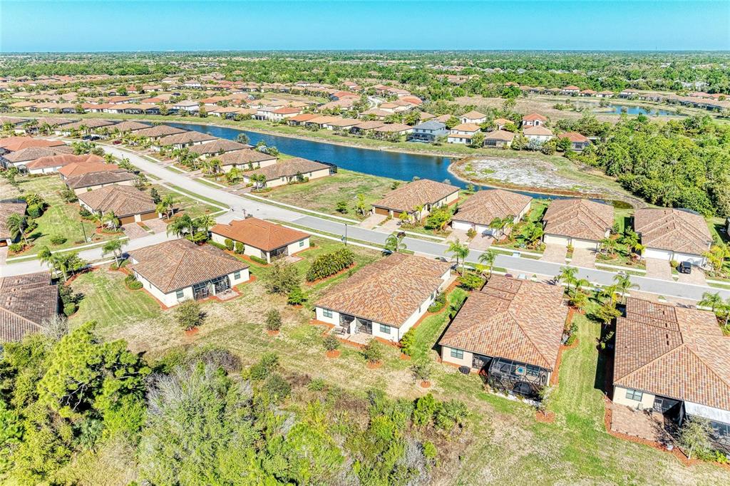 12434 Amica Loop Venice, FL 34293 - Photo 40 of 74 an aerial view of residential building and lake