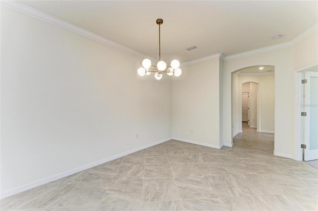 12434 Amica Loop Venice, FL 34293 - Photo 10 of 74 a view of a chandelier in big room and chandelier